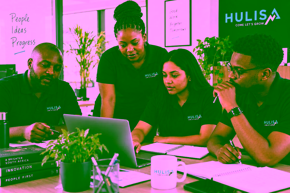 Hulisa-branded team reviewing a shared plan together in the office