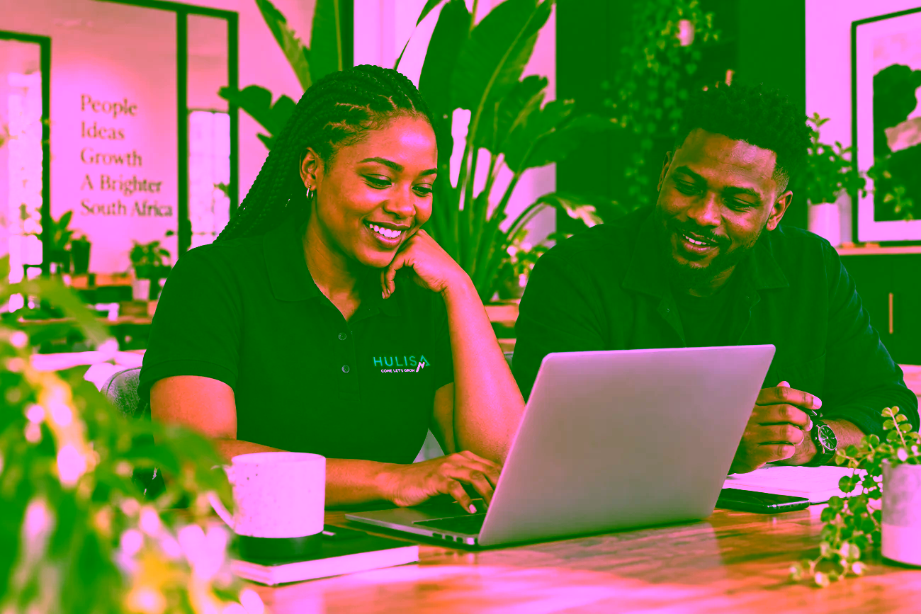 Illustrative collaborative team working together on a laptop